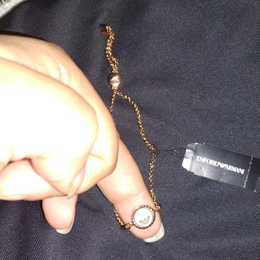 Emporio Armani stainless steel rose gold in color.  This bracelet is adjustable.